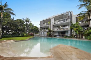 Relax by the pool surrounded by lush greenery and enjoy the hotel's contemporary design.