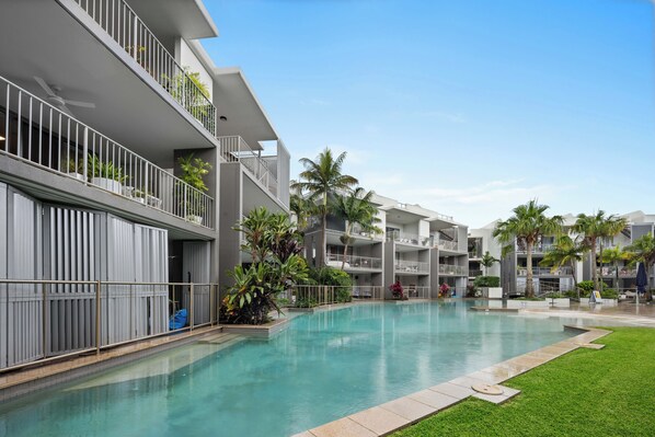 Relax by the pool surrounded by lush greenery and enjoy the serene atmosphere.