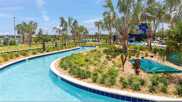 A pool area with palm trees, a water slide, and lounge chairs. - Your 5bdr House w Pool - 4959 (Kissimmee)