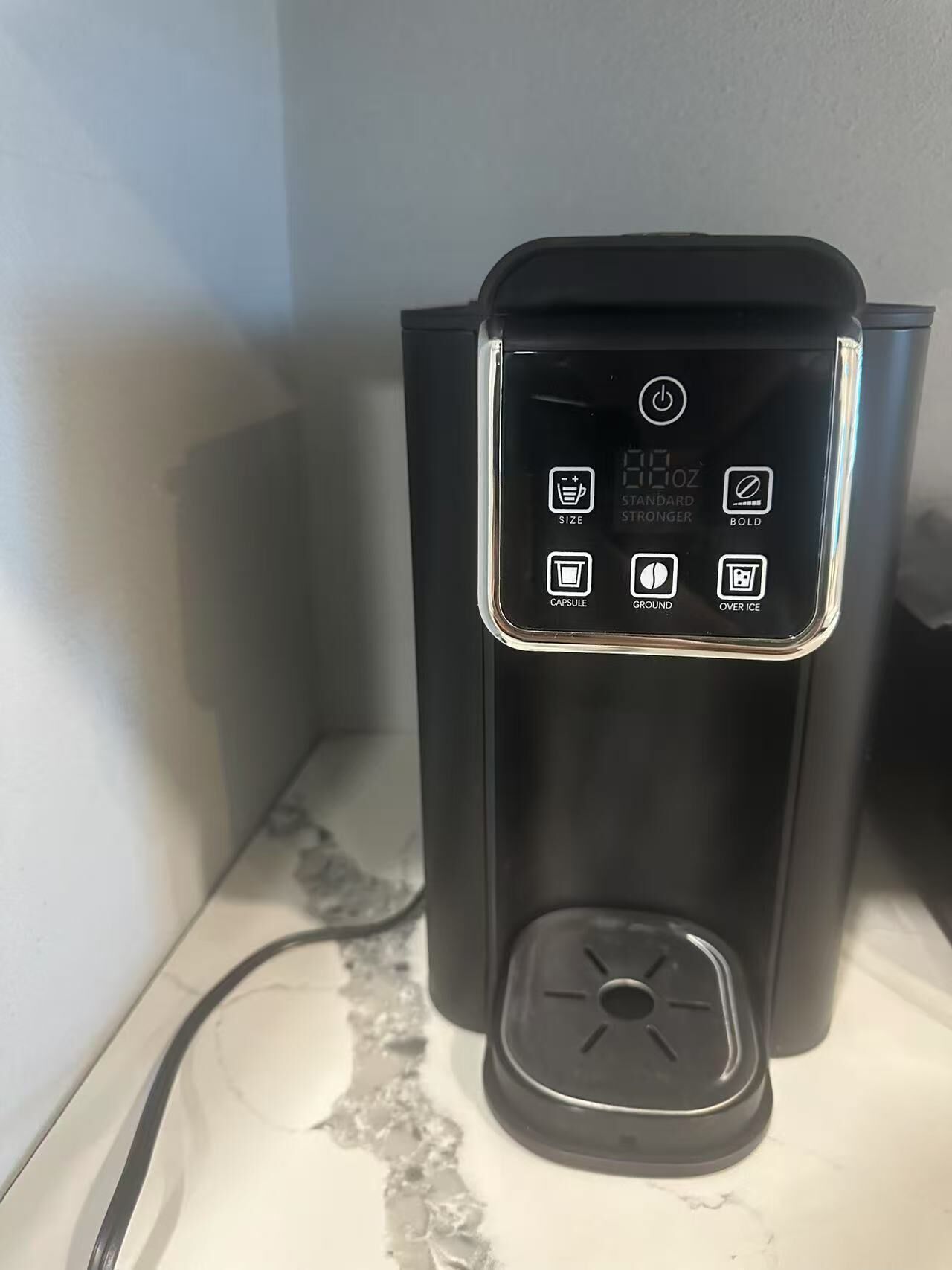 A coffee maker with a digital display and various settings options.