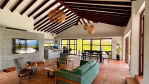 A spacious living area with a green sofa, a wooden coffee table, and a TV mounted on the wall. - U-GO Toledo 78 (Montenegro)