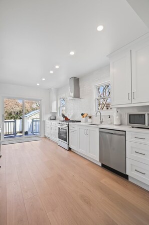 Enjoy cooking in this well-lit kitchen with stainless steel appliances and a large island.