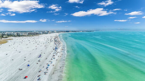 A wide beach with clear turquoise waters and a long stretch of sand. - Beachside Haven | Steps from Siesta Beach – Stunning 3-Bedroom Townhouse with Pool (Siesta Key)