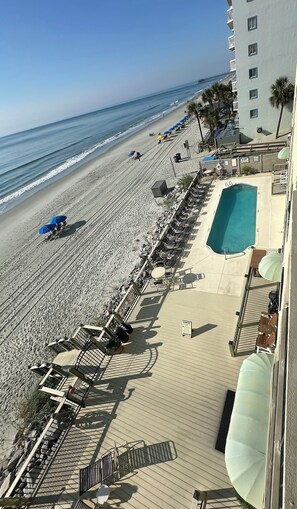 A beachside hotel with a pool, sun loungers, and a view of the ocean. - Horizon East 303 - Oceanfront in Garden City Beach (Garden City)