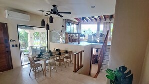 A spacious dining area with a high ceiling, a ceiling fan, and a view of the outdoor patio. - Cancún Energy, Tulum Spirit  Luxe & Private Stay (Cancún)