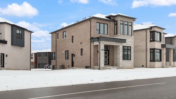 A modern residential building with a brick facade, large windows, and a flat roof. - Newly Built Basement Suite – Comfort & Convenience (Markham)