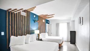 A hotel room with two beds, a wooden slat wall, a clock, and a TV. - NEW LISTING! 4 Bedroom Combined Suites (Miami Beach)