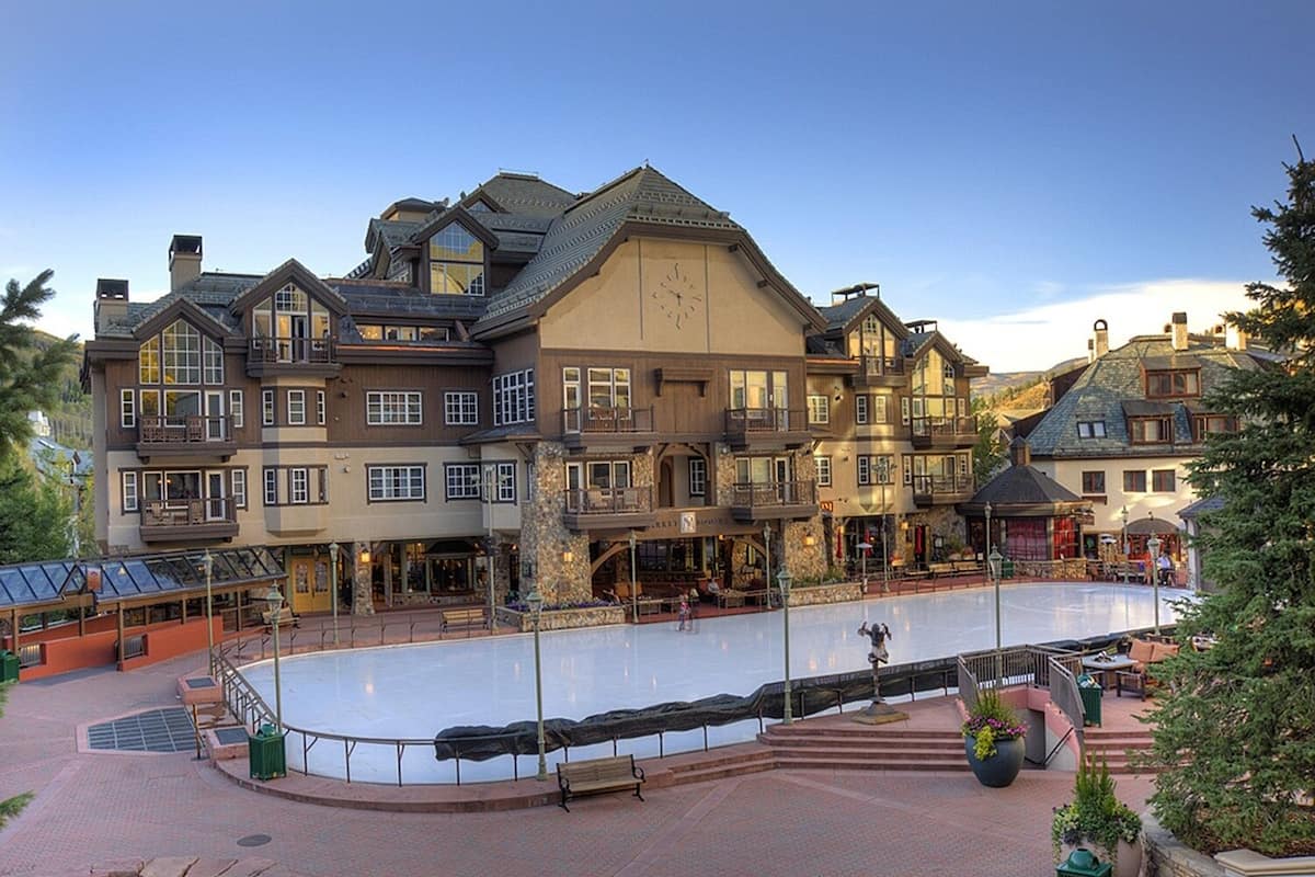 A large, multi-story hotel with a central courtyard featuring an ice rink.