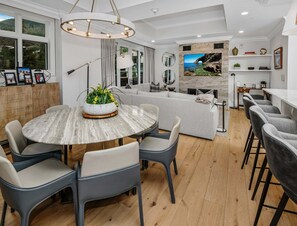 A modern living room with a round dining table, grey sofas, and a fireplace. - Vail Ski Resort Ritz Carlton Vacation Rentals (Vail)