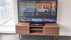 A television displaying a YouTube interface with various recommended videos and playlists. - Burnaby Metropolis Metrotown/1bedroom Condo/AC/Skytrain/Pool/Gym (Burnaby)