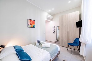 A modern bedroom with a bed, a chair, a TV, and a mirror. - Lovely Apartment In Genova Historic Center A/C B, Genova, Italy (Genova)