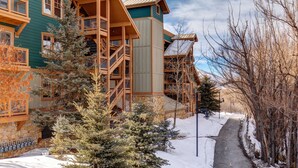 A multi-story wooden building with a snow-covered pathway and trees. - Park City Ski Resort - Town Pointe Condos (Park City)