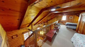 A wooden cabin with a loft bedroom, a dining area, and a staircase. - Pack Creek - M4, Log Cabin at Pack Creek Ranch (Moab)