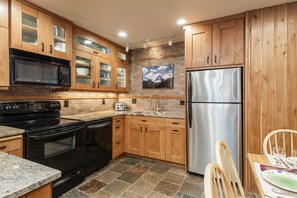 Enjoy cooking in this well-equipped kitchen with a refrigerator, oven, microwave, and toaster.