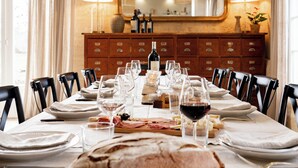 A dining table set for a meal with wine glasses, plates, and a variety of food items. - Pressoir de la Fleur (néac)