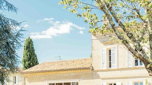 A two-story house with a tiled roof, large windows, and a well-maintained lawn. - Pressoir de la Fleur (néac)