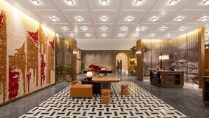 A hotel lobby with a patterned floor, a reception desk, seating area, and a decorative wall. - UrCove by Hyatt Xi'an Bell Tower Huimin Street (Xi'an)