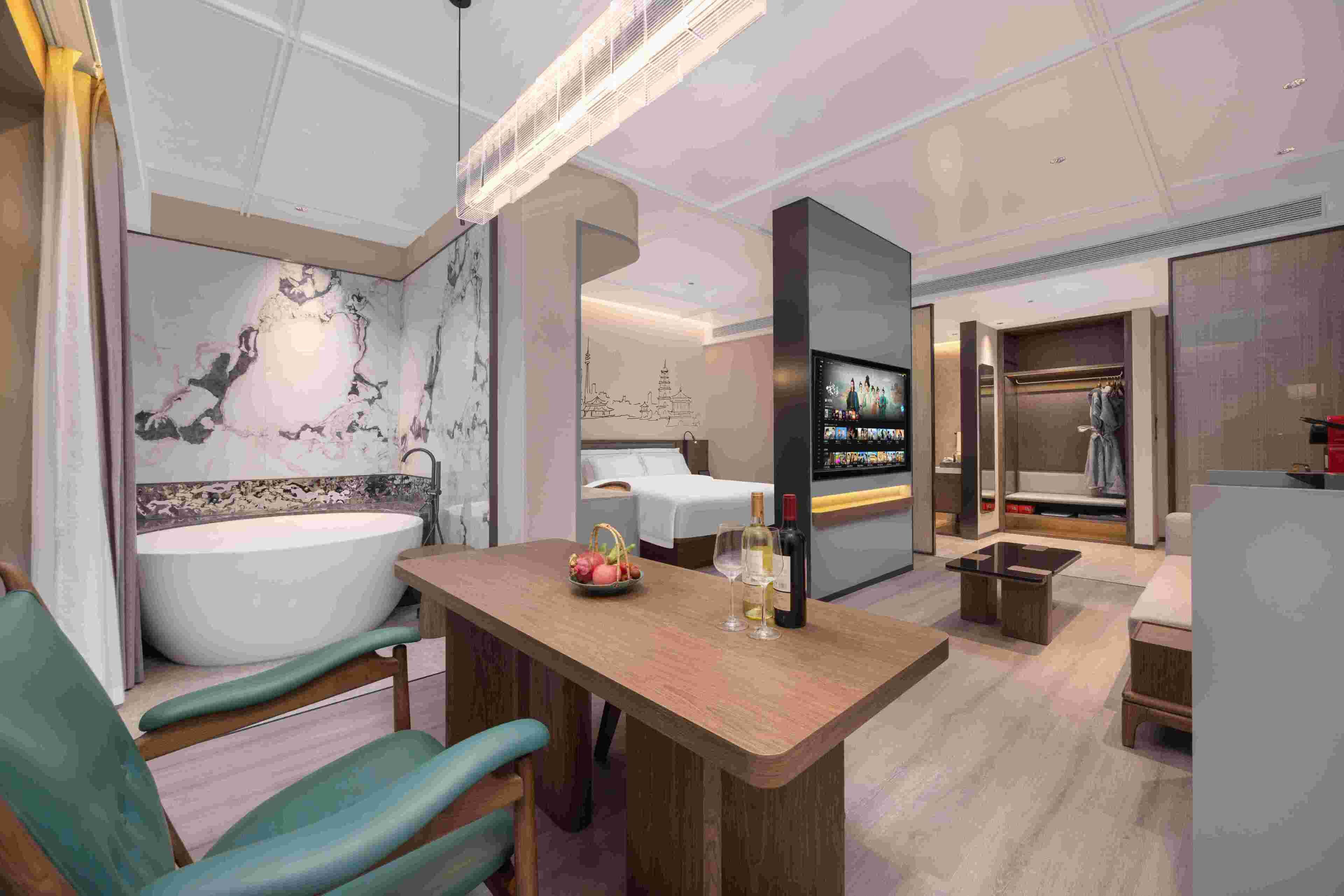 A modern bathroom with a large bathtub, a vanity with a mirror, and a shower area.