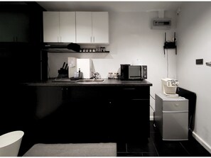 Fridge, microwave, coffee/tea maker, cookware/dishes/utensils