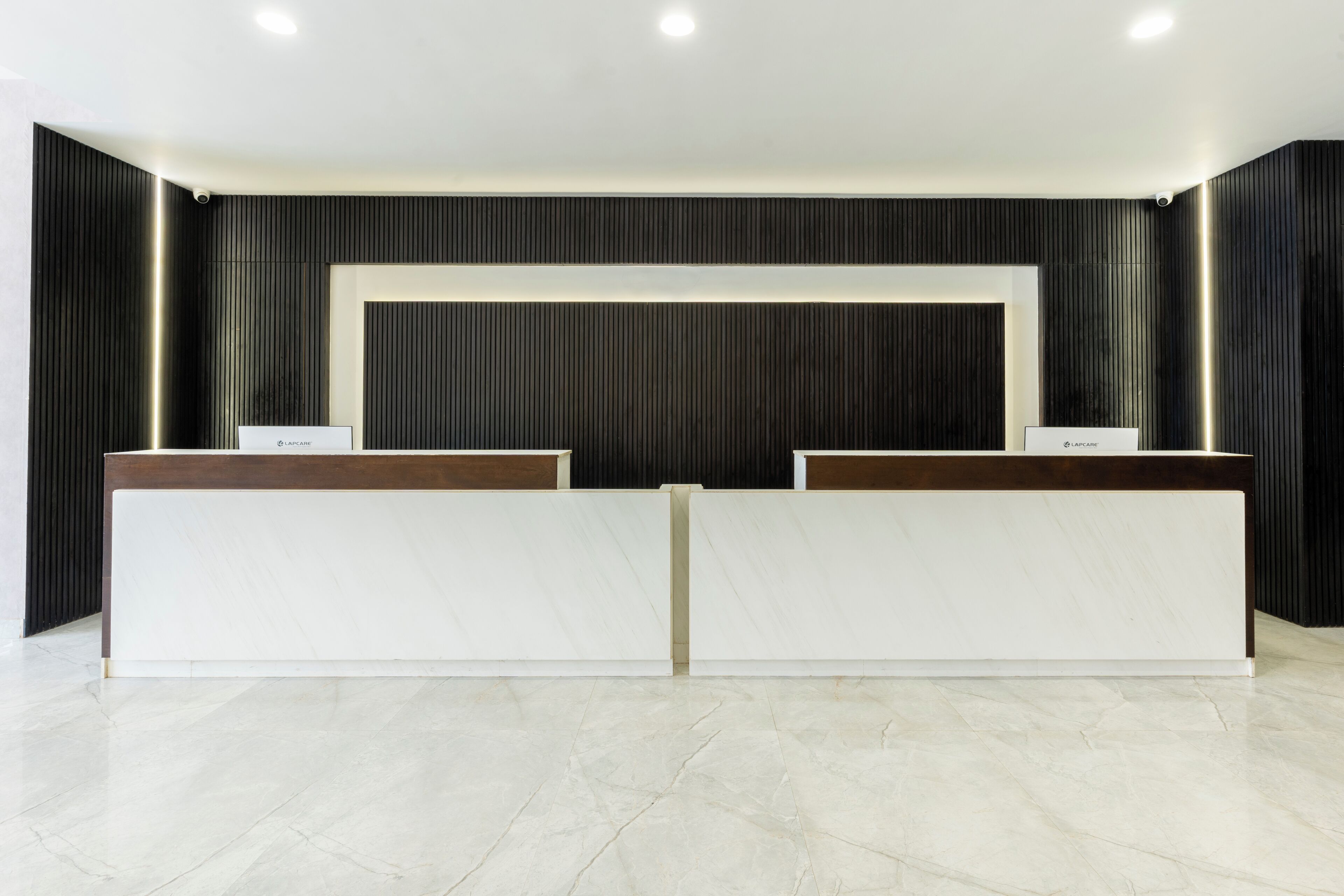 A reception desk with a modern design, featuring two counters and a central panel.