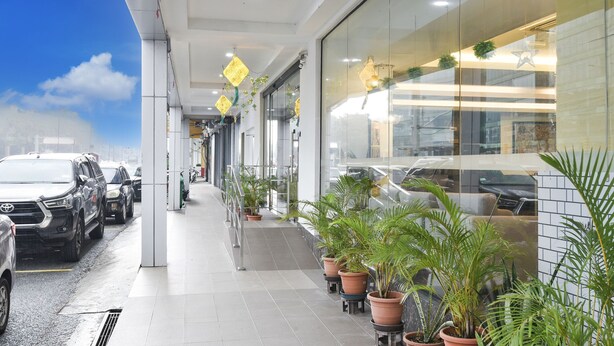 A modern building with a covered parking area, potted plants, and a clear sky. - Palette KL Sentral near Pudu LRT formerly RPC Blissful Homes (Kuala Lumpur)