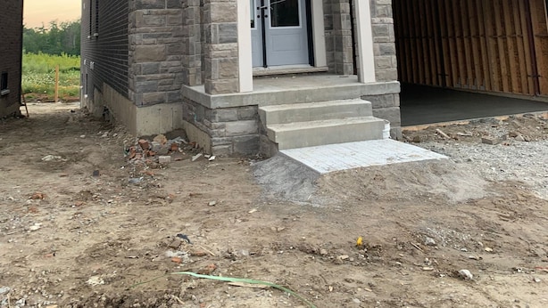 A two-story house with a stone facade, a front entrance with steps, and a garage. - Very  Spacious  , Cosy  and attractive 
 property. (Vaughan)