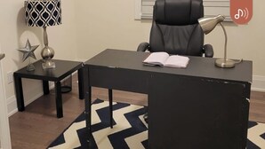 A modern office space with a desk, chair, lamp, and a patterned rug. - Very  Spacious  , Cosy  and attractive 
 property. (Vaughan)