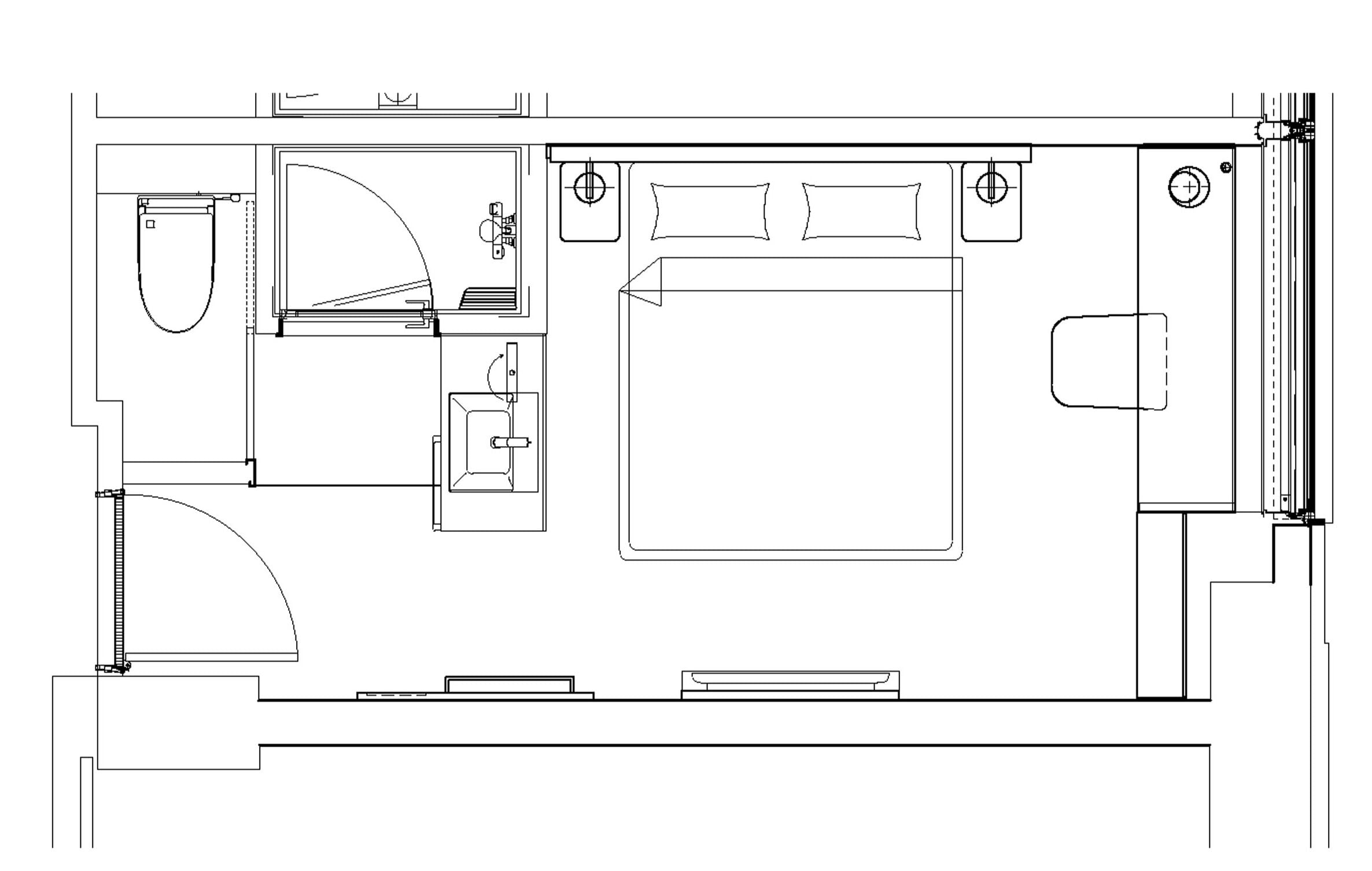 A floor plan of a hotel room with a bed, a bathroom, a desk, and a small seating area.