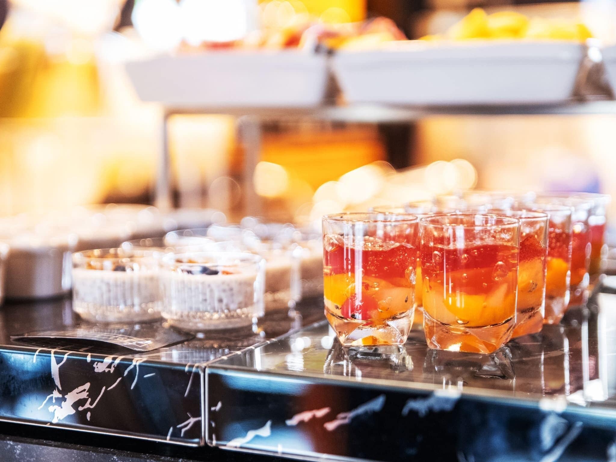 A buffet with various food items and beverages.