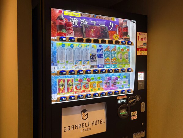A vending machine with various drink options and a Coca-Cola logo.