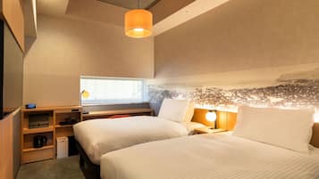 A modern hotel room with two beds, a desk, a small seating area, and a cityscape view.
