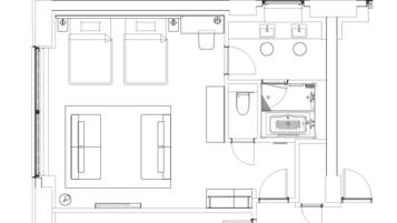 Plano detallado de un hotel que muestra varias habitaciones, un vestíbulo central y una zona de baños.
