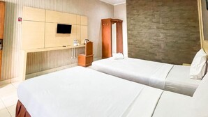 A hotel room with two beds, a TV mounted on the wall, a wooden wardrobe, and a stone accent wall. - Hotel Posters (Bandung)