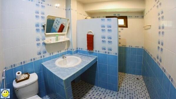 A bathroom with a sink, toilet, and mirror. - D&K Smiley Phuket Resort (Rawai)