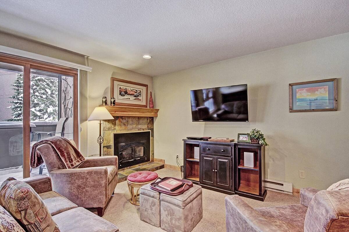 A living room with a fireplace, a television, and a sofa.