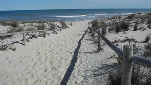 A sandy beach path leading to the ocean with a wooden fence on the right. - 4 bedroom accommodation in Harvey Cedars (Harvey Cedars)