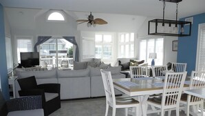 A spacious living area with a sofa, dining table, chairs, and a ceiling fan. - 4 bedroom accommodation in Harvey Cedars (Harvey Cedars)