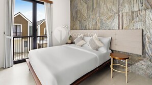 A modern hotel room with a large bed, a wooden nightstand, and a view of the outside. - Serila Villa by Kozystay - Jimbaran (Jimbaran)