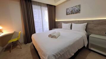 Premium bedding, desk, laptop workspace, free WiFi