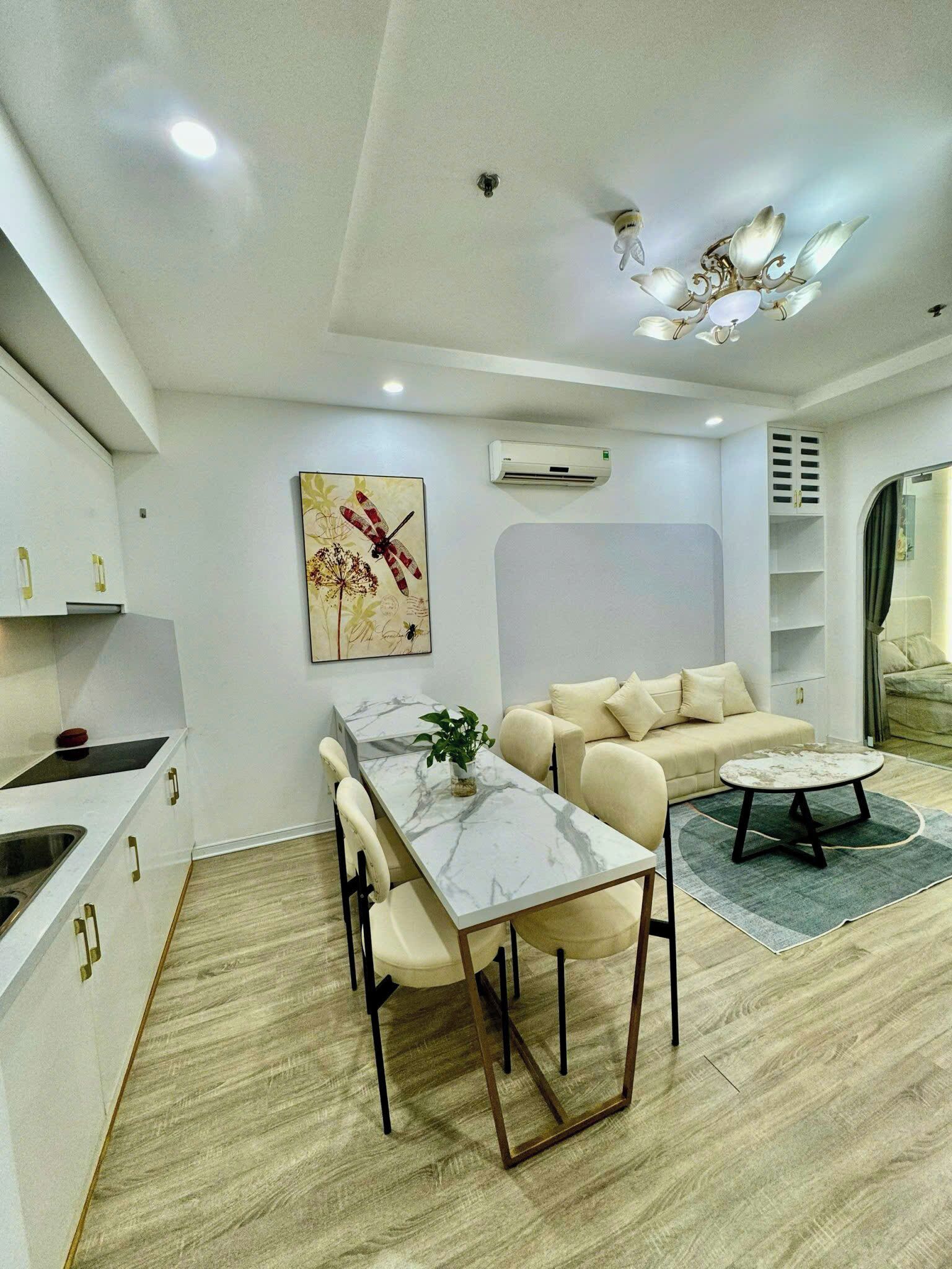 A modern living space with a kitchen, dining area, and seating area.