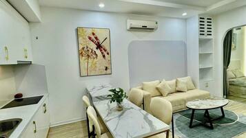 A modern living space with a kitchen, dining area, and seating area.