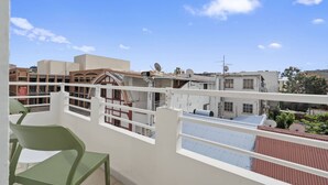 A balcony with a view of surrounding buildings and a clear sky. - Le Botanik: Chic Garden (Fort-de-France)