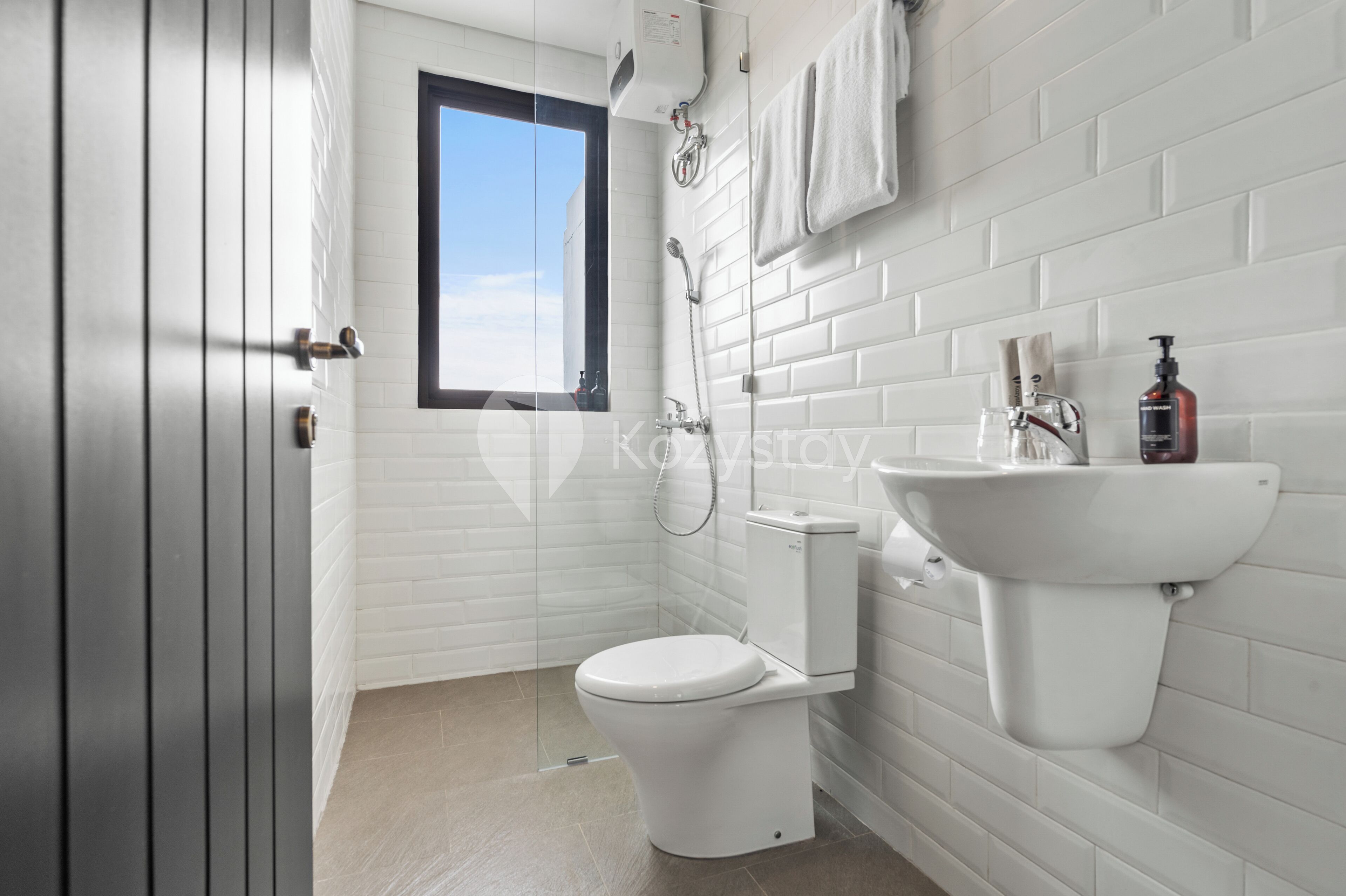 A modern bathroom with a toilet, sink, and shower.