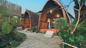 A rustic-style building with a paved walkway leading to the entrance. - Navalia Villa Bedugul (Baturiti)