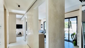 A modern interior with a hallway leading to a living area. - The Flexrent Port - Abyssinia (Riccione)