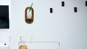 A bathroom with a wooden towel rack, a white sink, and a mirror. - moneystay deagu (Daegu)