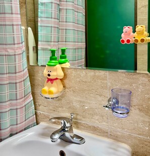 A bathroom with a white sink, a mirror, and a green wall. There are two soap dispensers shaped like dogs and a glass on the wall. - moneystay deagu (Daegu)
