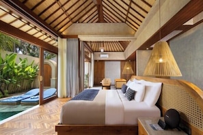 A bedroom with a bed, bedside table, lamp, and a view of a pool. - Asvara Resort & Spa Ubud by Ini Vie Hospitality (Ubud)