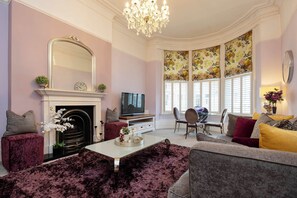 A living room with a fireplace, television, and comfortable seating.