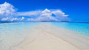 Beach nearby, white sand, beach umbrellas, beach towels